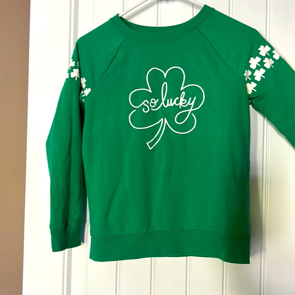 Girls green sweatshirt with clovers on sleeves and “so lucky” on front